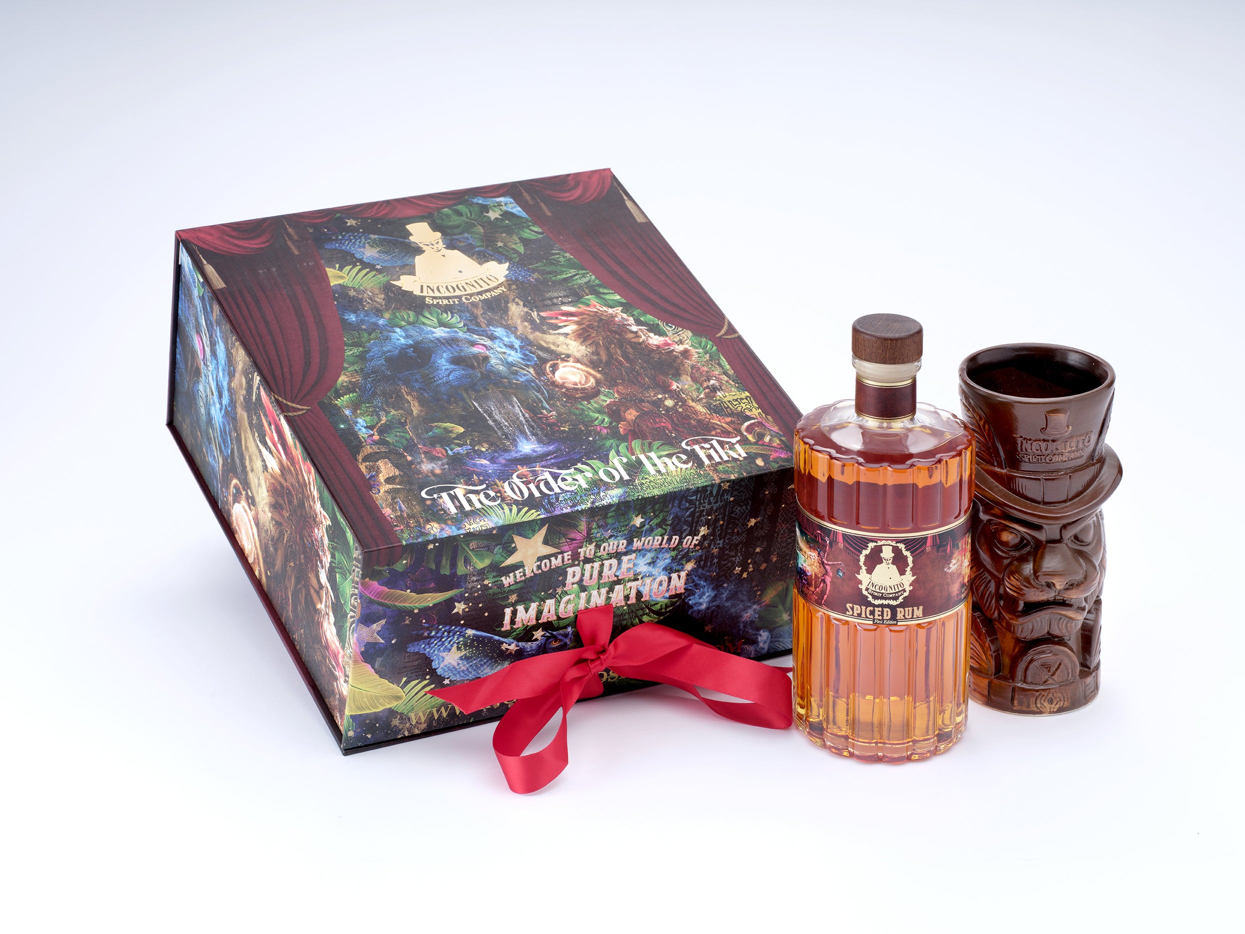 A bottle of Tiki Rum whisky with its illustrated gift box and a carved wooden tiki cup on a white background.