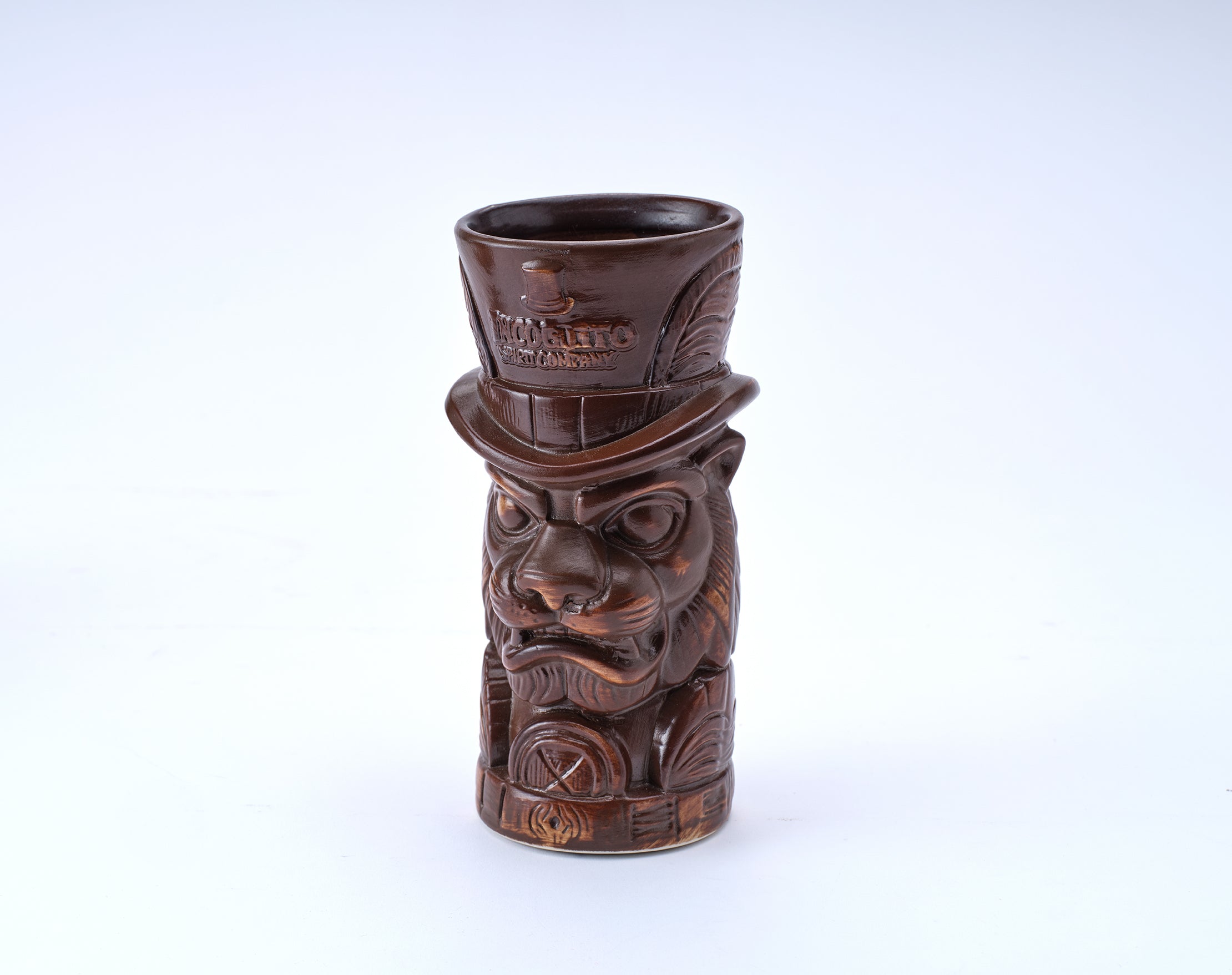 A dark brown ceramic tiki mug shaped like a carved tiger head wearing a top hat, with 'TOKYO SHO' embossed on the hat, set against a plain white background.
